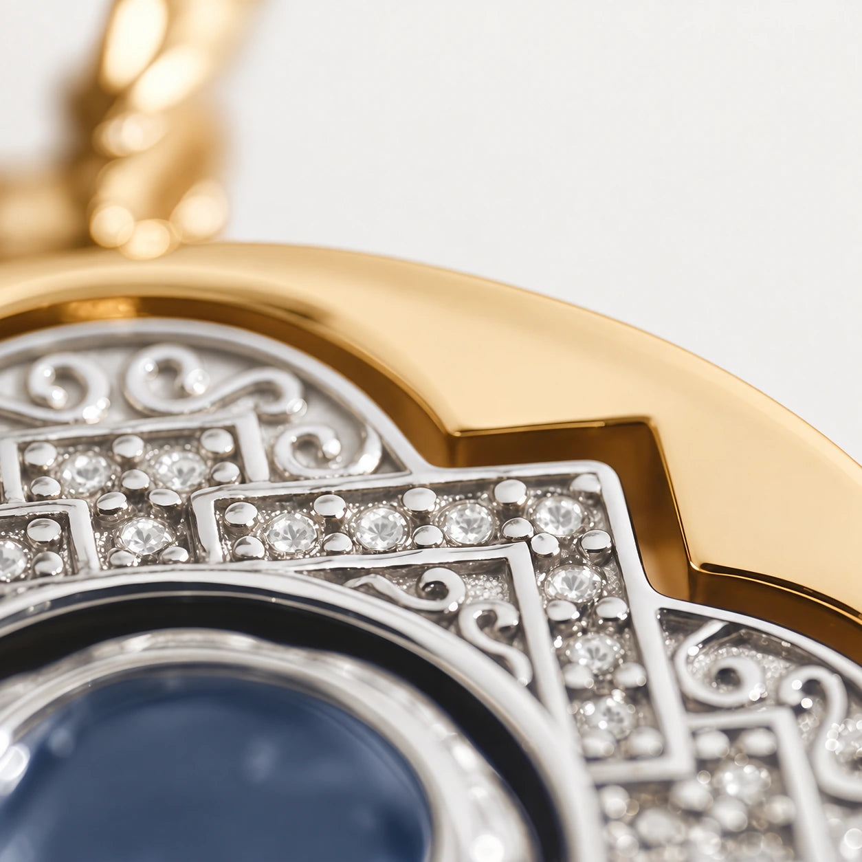 Close-up of the necklace’s silver detailing, polished gold edge and sealed mandala sand