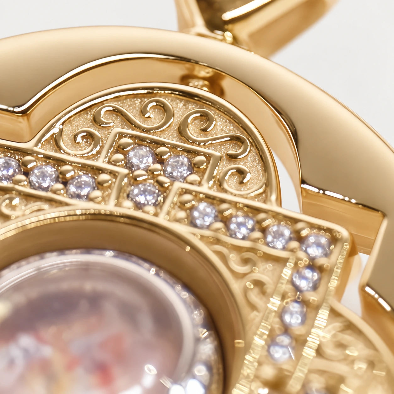 Close-up of the gold necklace, its sculpted setting and mandala sand